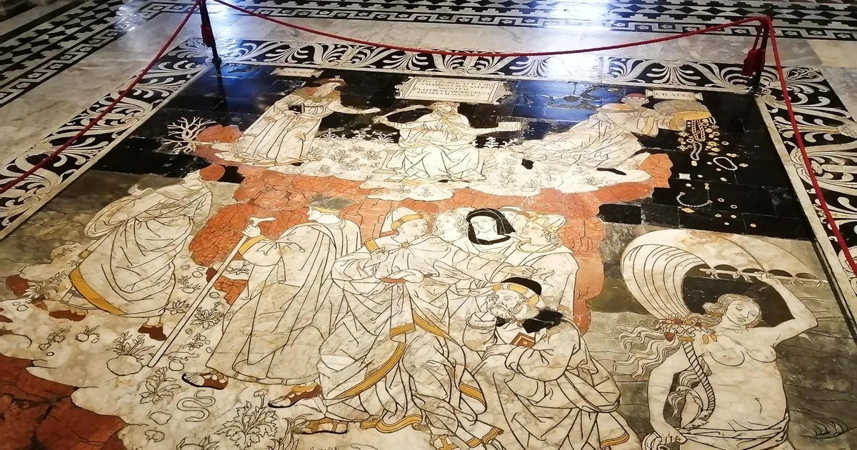 Part of the inlaid marble floor of Siena Cathedral: pale figures on dark and red marble, roped off for visitors